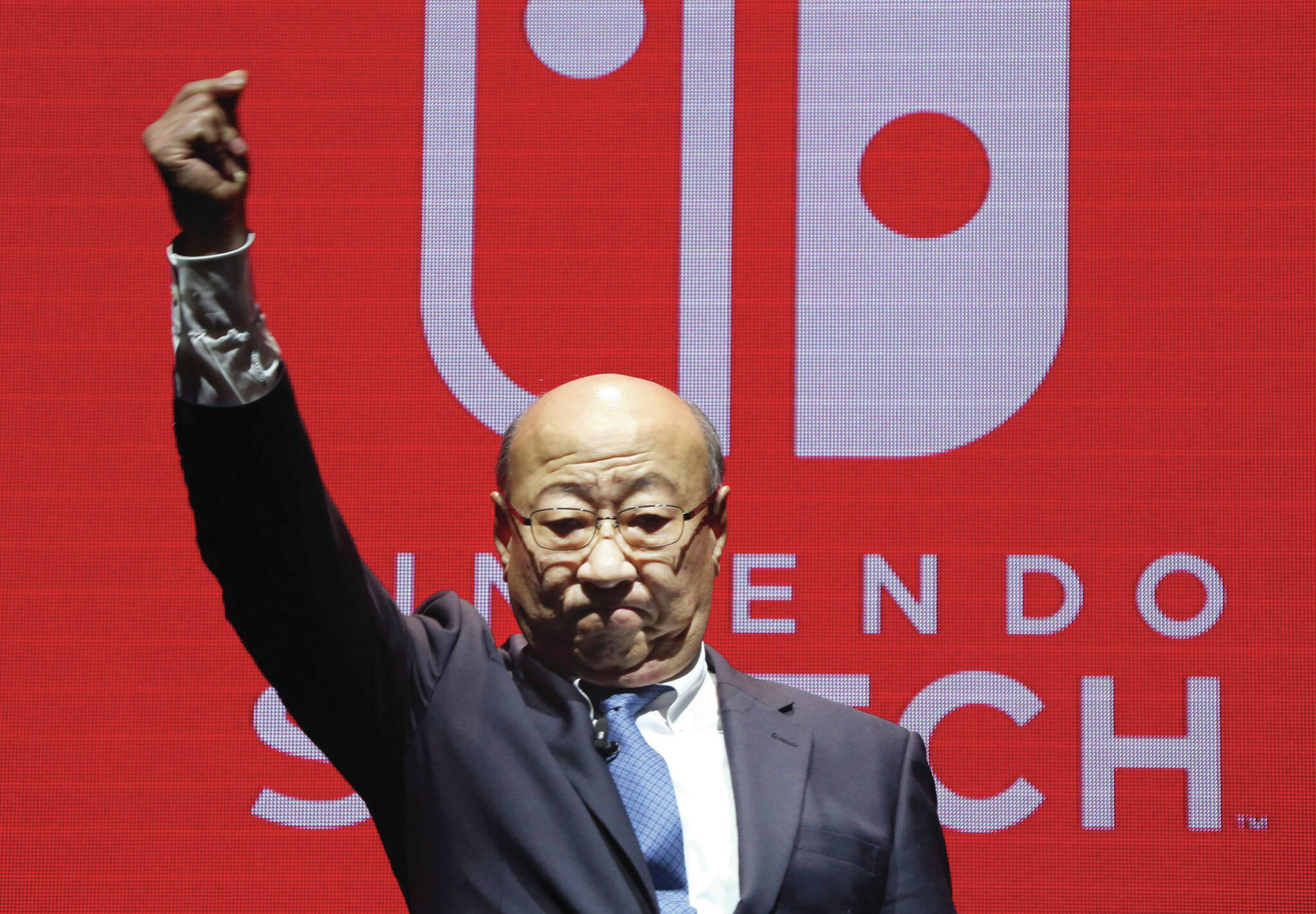 President of Nintendo Tatsumi Kimishima reacts after his speech during a presentation event of Nintendo Switch in Tokyo, Friday, Jan. 13, 2017. Nintendo Co. said Friday that its Nintendo Switch video game console will sell for 29,980 yen (about $260) in Japan, starting March 3. (AP Photo/Koji Sasahara)