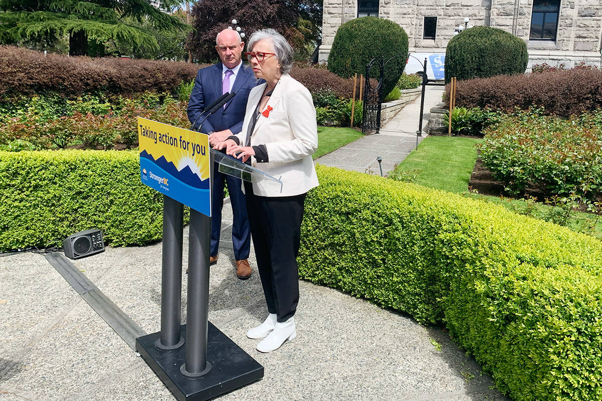 Public Safety Minister Mike Farnworth and Mental Health and Addictions Minister Jennifer Whiteside address the media outside the provincial legislature after Ottawa had announced that it would grant B.C.’s request to amend the terms of decriminalization. They will make illicit drug use illegal in all public spaces including parks, hospitals and on transit. Original terms of the pilot project had prohibited police from arresting, charging or seizing adults in possession of up to 2.5 grams of heroin, cocaine, crack, crystal meth, MDMA or fentanyl. (Wolf Depner/News Staff)