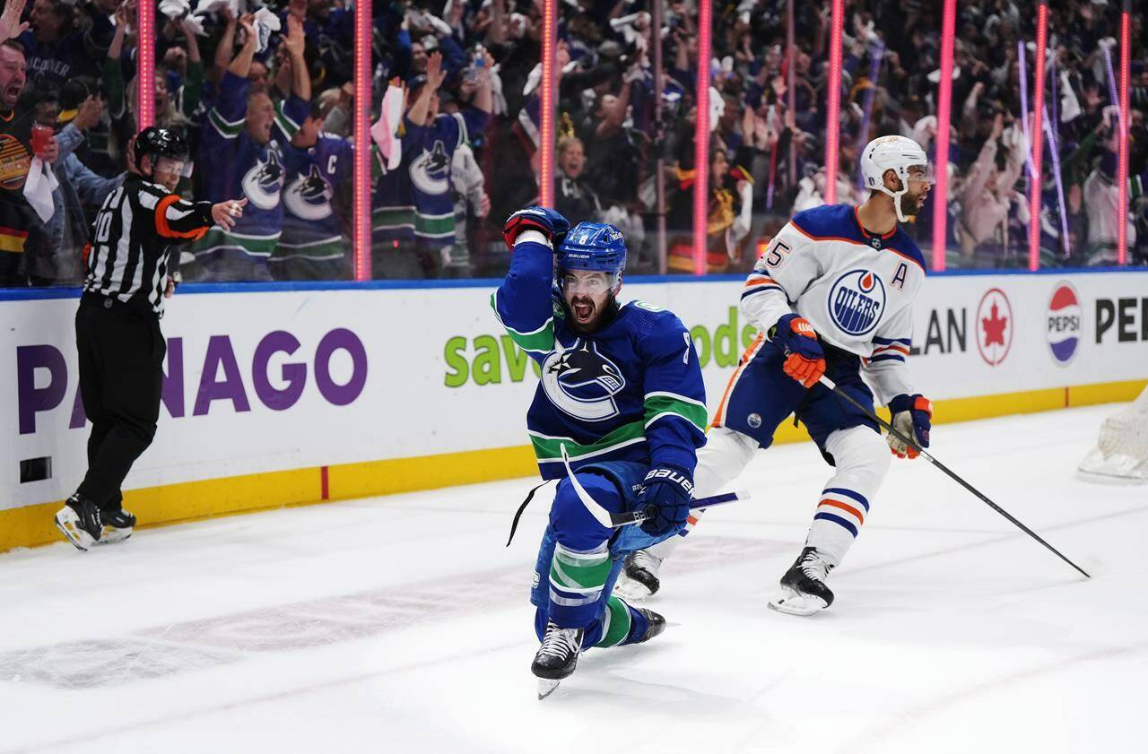 Vancouver Canucks’ Conor Garland, left, celebrates his goal as Edmonton Oilers’ Darnell Nurse reacts during the third period in Game 1 of an NHL hockey Stanley Cup second-round playoff series, in Vancouver, on Wednesday, May 8, 2024. THE CANADIAN PRESS/Darryl Dyck