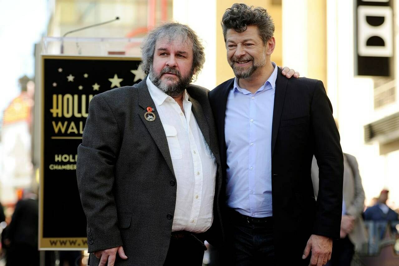 FILE - Peter Jackson, left, director, co-writer and producer of the film trilogies “The Lord of the Rings and “The Hobbit,” poses with actor Andy Serkis during a ceremony honoring Jackson with a star on the Hollywood Walk of Fame in Los Angeles on Dec. 8, 2014. (Photo by Chris Pizzello/Invision/AP, File)