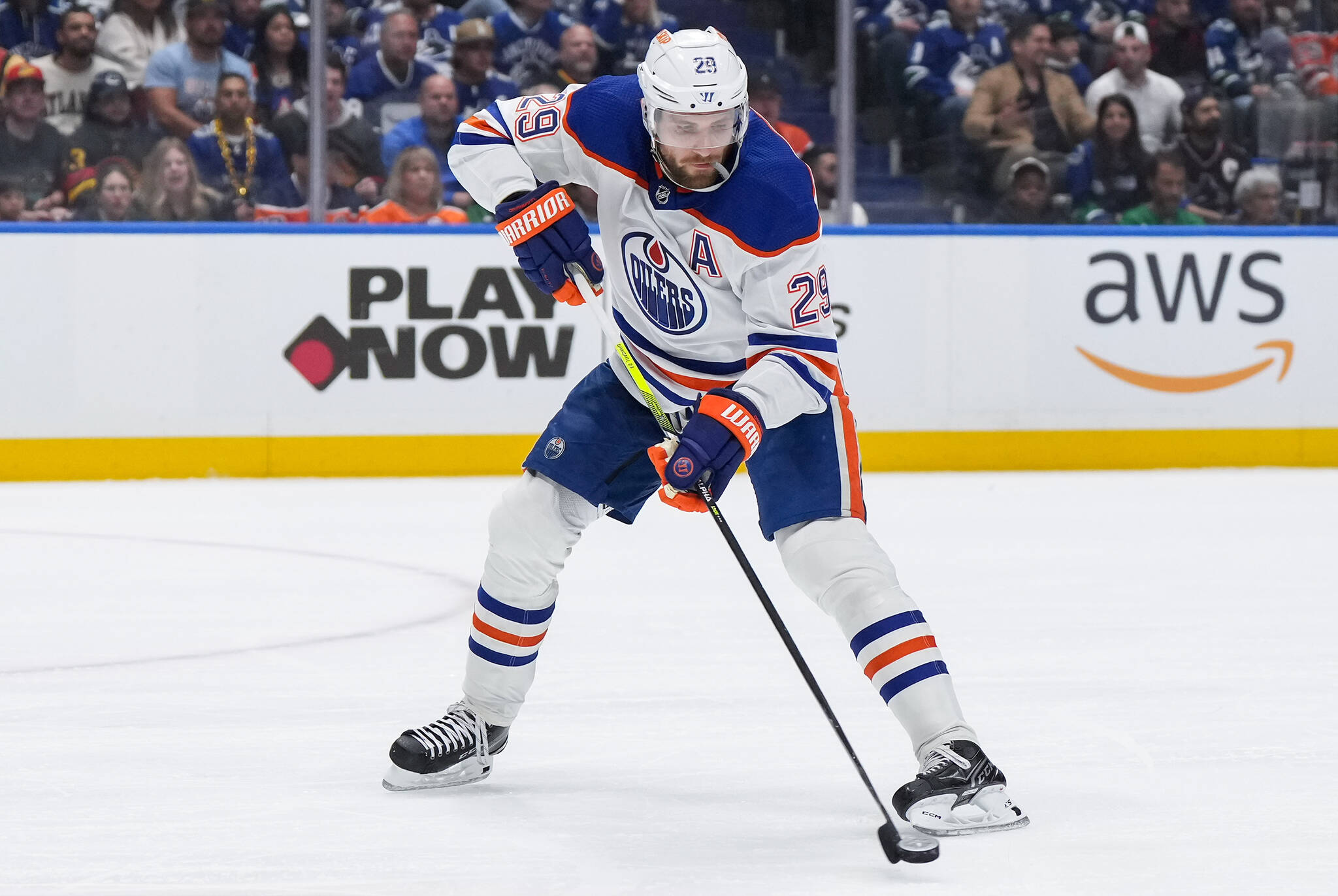 Edmonton Oilers’ Leon Draisaitl passes the puck during the first period in Game 1 of an NHL hockey Stanley Cup second-round playoff series against the Vancouver Canucks, in Vancouver, on Wednesday, May 8, 2024. THE CANADIAN PRESS/Darryl Dyck