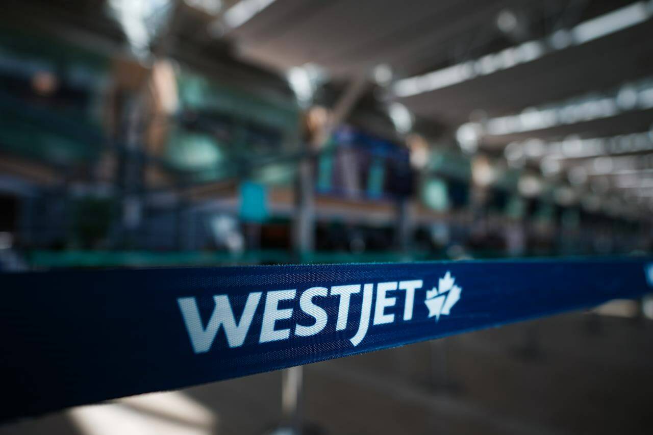 A WestJet logo is seen in the domestic check-in area at Vancouver International Airport, in Richmond, B.C., on Friday, May 19, 2023. The union representing WestJet Encore pilots says its members rejected a tentative deal reached last month, with just over half voting the agreement down. THE CANADIAN PRESS/Darryl Dyck