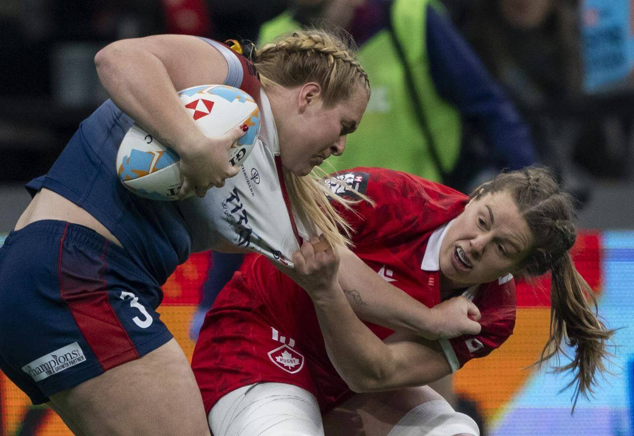 FILE - Canada’s Sophie De Goede grabs Great Britain’s Abi Burton during Vancouver Sevens women’s rugby action in Vancouver, on Friday, Feb. 23, 2024. Calif. THE CANADIAN PRESS/Ethan Cairns
