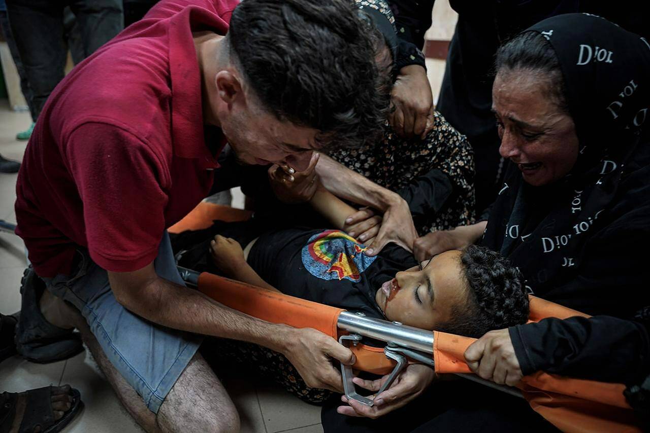 Palestinians mourn their child relative killed in the Israeli bombardment of the Gaza Strip, at Al Aqsa Hospital in Deir al Balah, Gaza Strip, early Sunday, May 12, 2024. (AP Photo/Saher Alghorra)