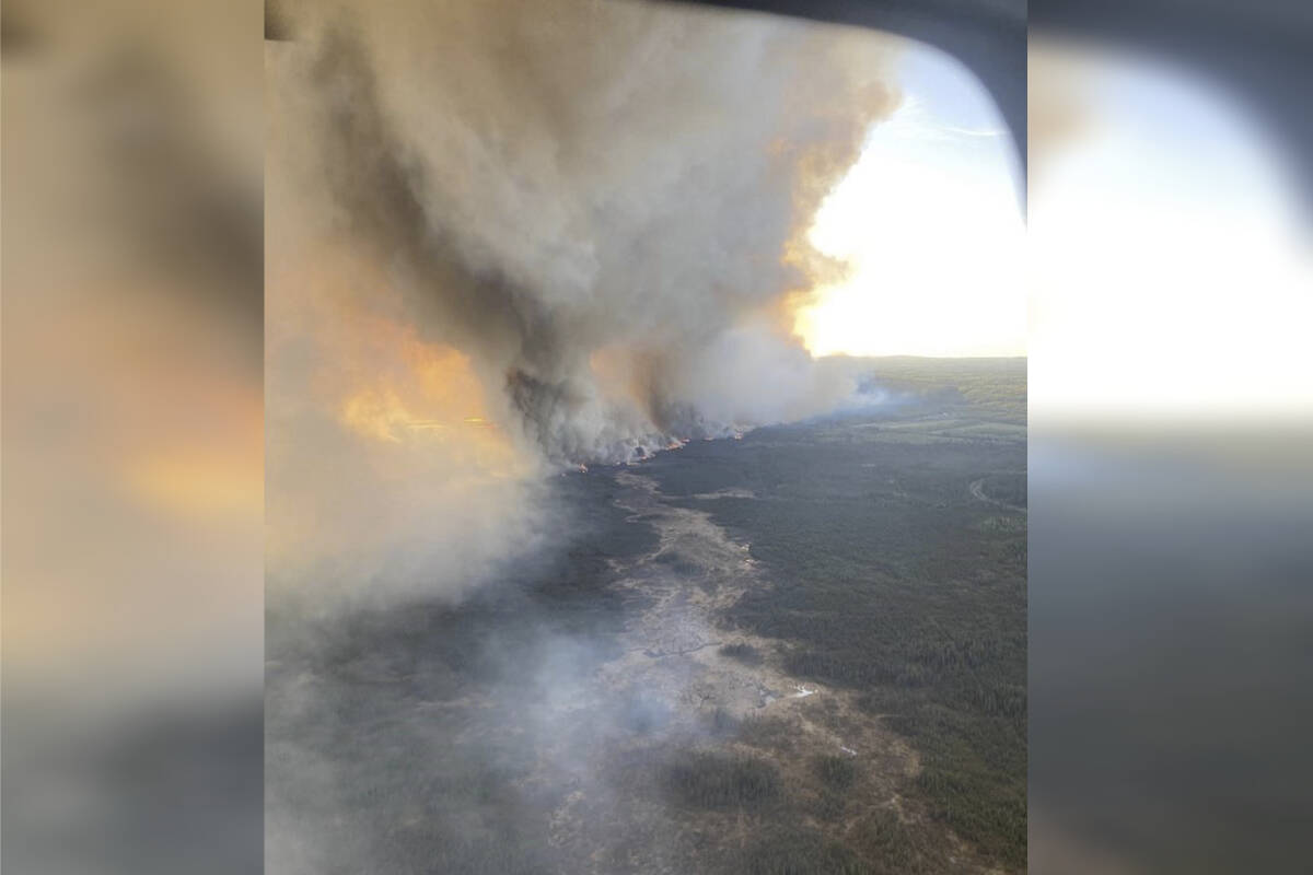 The wildfire forcing thousands to evacuate from a northeast British Columbia town may grow again on Sunday (May 12) with winds expected to pick up in the evening. The Parker Lake wildfire, officially designated G90267, is seen through an aircraft window as it burns near Fort Nelson, B.C., in a Friday, Sept. 10, 2024, handout photo. THE CANADIAN PRESS/HO-B.C. Wildfire Service