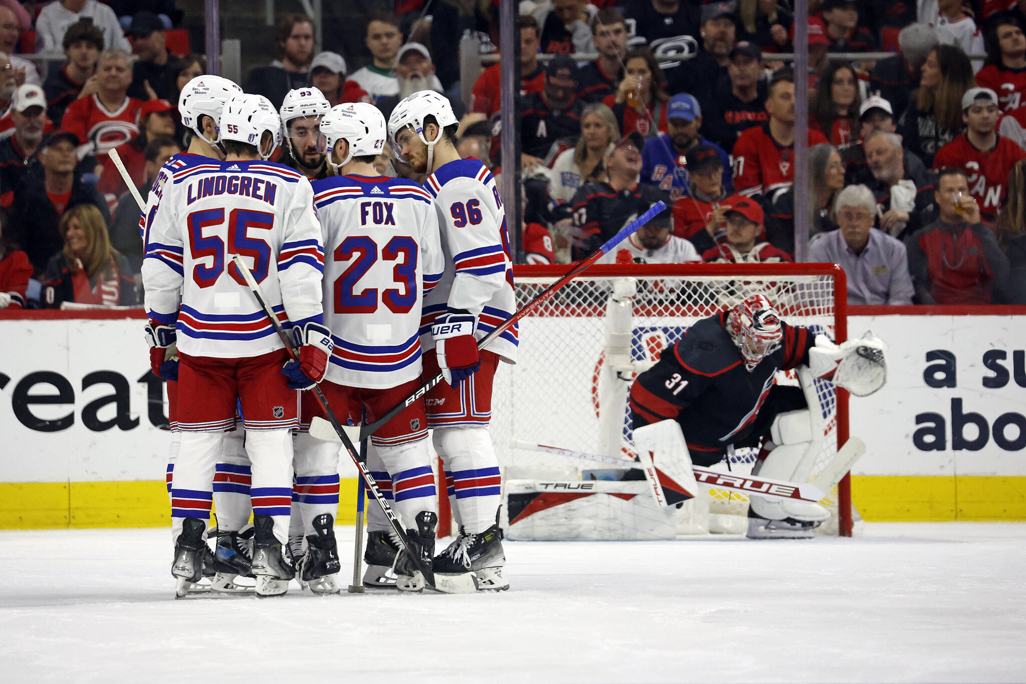 New York Rangers huddle during a timeout as Carolina Hurricanes goaltender Frederik Andersen (31) stretches by the net during the second period in Game 4 of an NHL hockey Stanley Cup second-round playoff series in Raleigh, N.C., Saturday, May 11, 2024. (AP Photo/Karl B DeBlaker)
