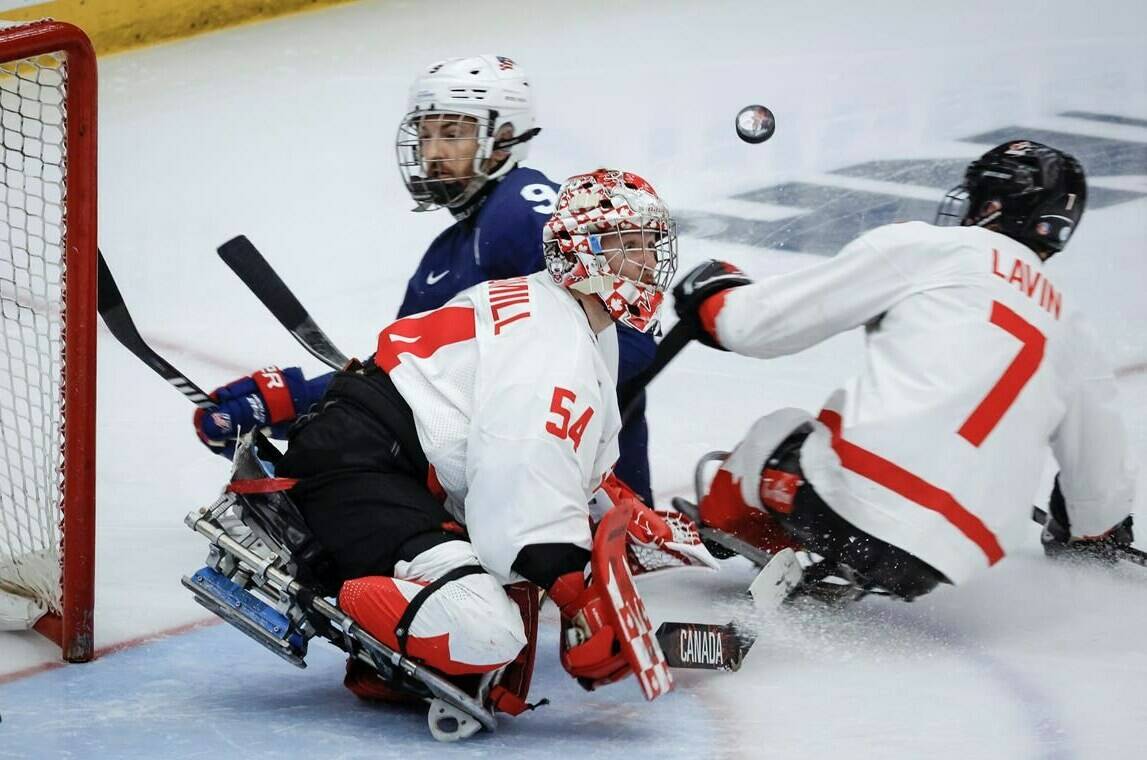 Team USA forward Travis Dodson (9) has his shot deflected by Team Canada goalie Adam Kingsmill (54) during second period action in the World Para Ice Hockey Championship final in Calgary, Sunday, May 12, 2024. THE CANADIAN PRESS/Jeff McIntosh