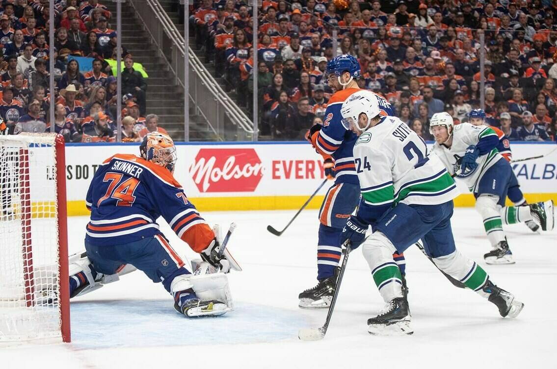 Vancouver Canucks’ Pius Suter (24) watches the puck go in the net past Edmonton Oilers goalie Stuart Skinner (74) during first period second-round NHL playoff action in Edmonton on Sunday May 12, 2024.THE CANADIAN PRESS/Jason Franson