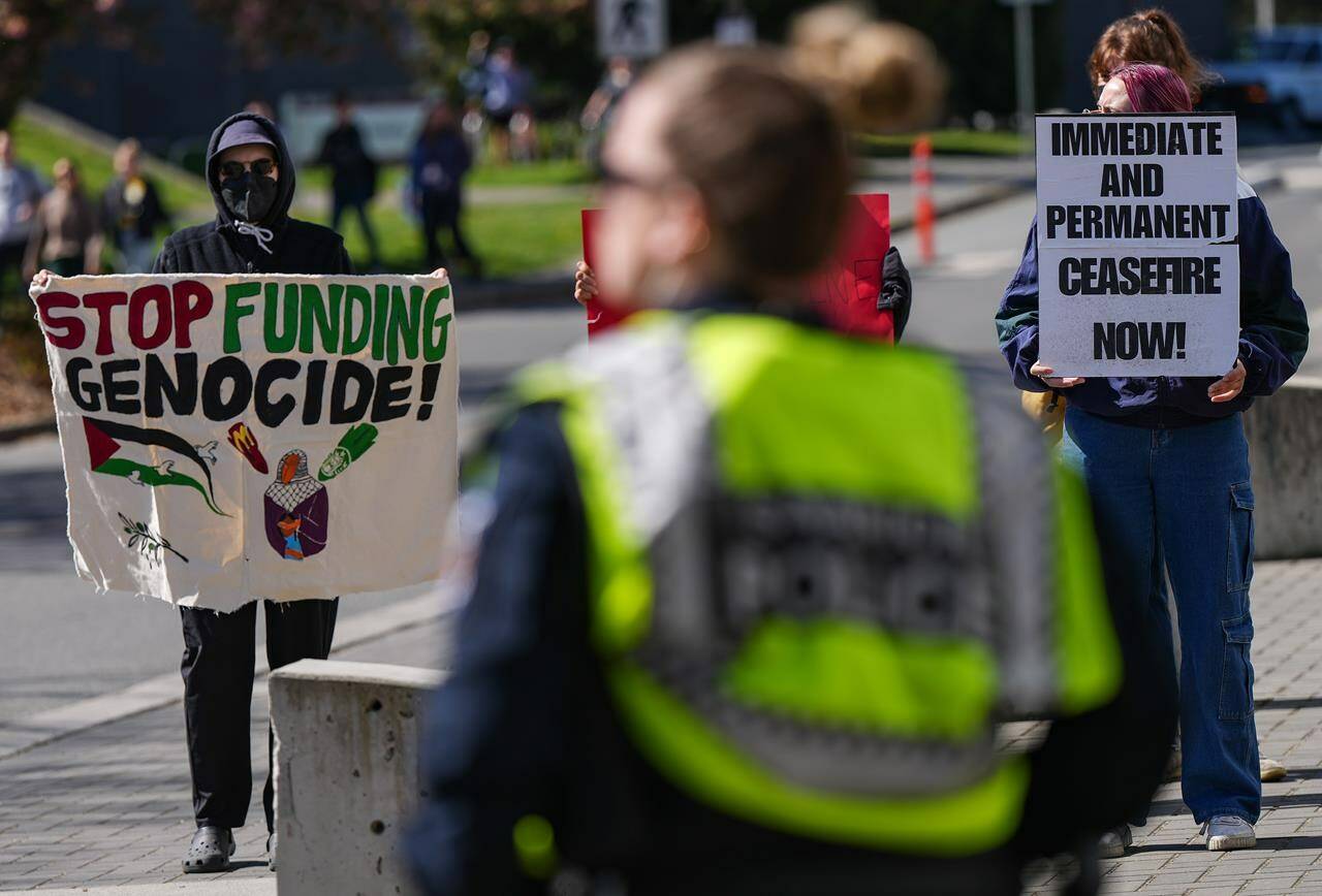 Pro-Palestinian protesters hold a demonstration during a visit by Prime Minister Justin Trudeau to the University of Victoria, in Saanich, B.C., on Friday, April 19, 2024. THE CANADIAN PRESS/Darryl Dyck