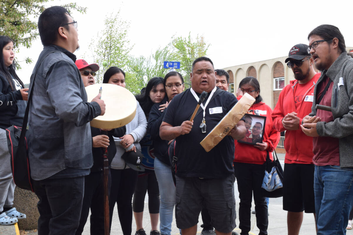 The family of Dontay-Patrick Lucas sings and drums outside of the Port Alberni courthouse on Thursday, May 16. (ELENA RARDON / Alberni Valley News)