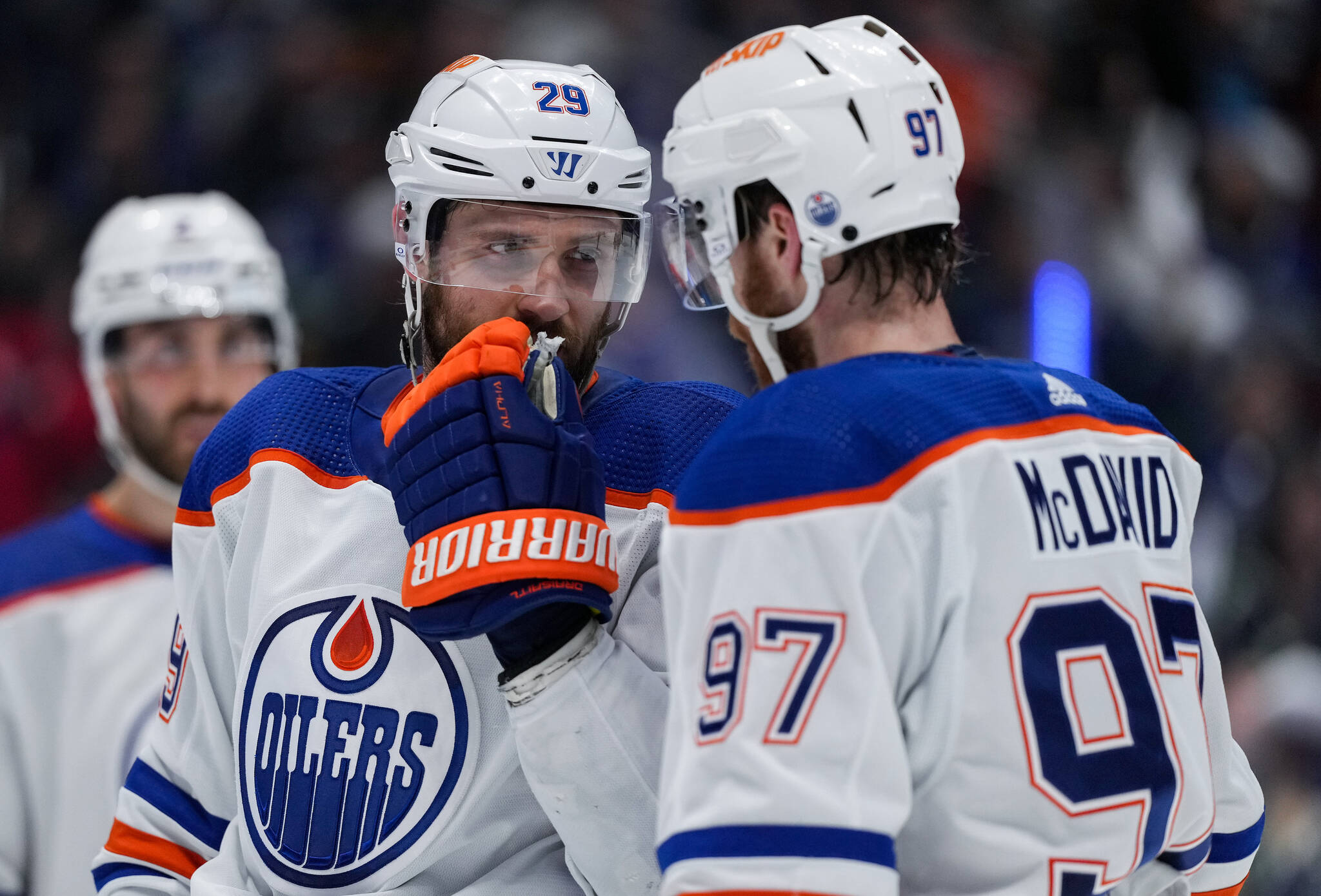 Edmonton Oilers’ Leon Draisaitl, back left, and Connor McDavid talk before a faceoff against the Vancouver Canucks during the second period in Game 5 of an NHL hockey Stanley Cup second-round playoff series, in Vancouver, on Thursday, May 16, 2024. THE CANADIAN PRESS/Darryl Dyck