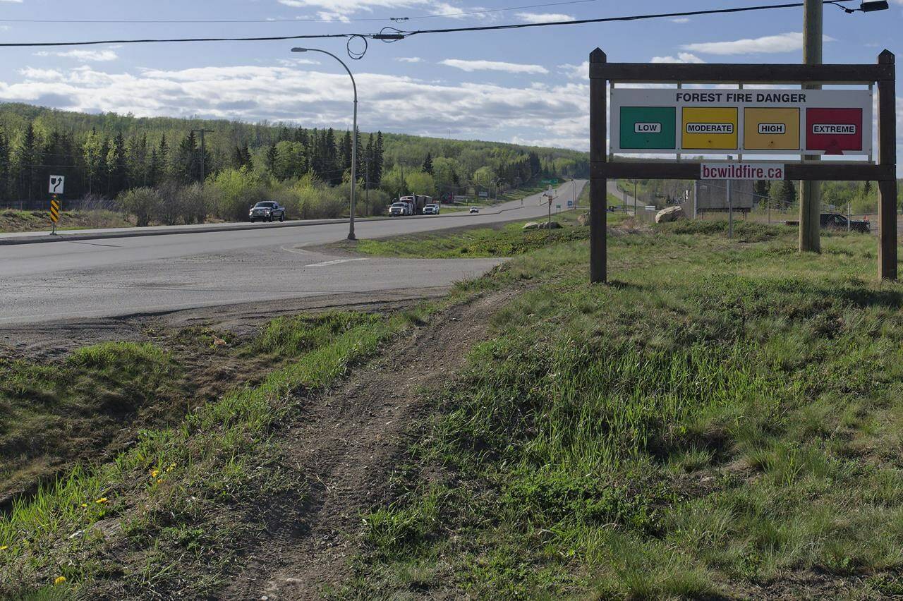 An extreme fire warning sign is shown along Highway 97 toward Fort Nelson outside the Charlie Lake Fire Hall near Fort St. John, B.C., on Monday, May 13, 2024. THE CANADIAN PRESS/Jesse Boily