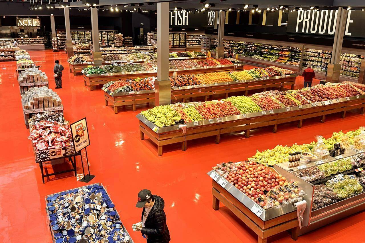 Prime Minister Justin Trudeau says with the biggest Canadian grocer now on board, the grocery code of conduct is much more likely to succeed. Shoppers browse goods in the produce section of a Toronto Loblaws on Friday, May 3, 2024. THE CANADIAN PRESS/Chris Young