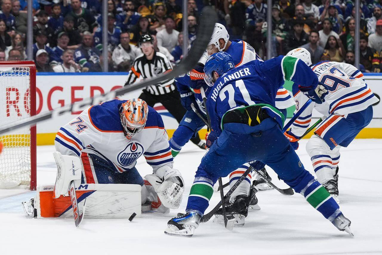 The Edmonton Oilers will start Stuart Skinner in net tonight for a must-win Game 6 of their second-round playoff series against the Vancouver Canucks. Skinner (74) stops Vancouver’s Nils Hoglander (21) as teammates Darnell Nurse, back centre, and Ryan Nugent-Hopkins, back right, defend during first period Game 2 NHL Stanley Cup second-round playoff hockey action, in Vancouver, B.C., Friday, May 10, 2024. THE CANADIAN PRESS/Darryl Dyck