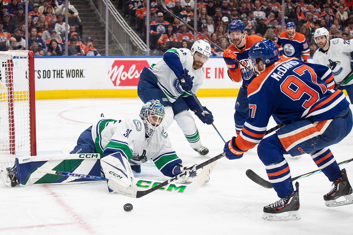 Vancouver Canucks’ goalie Arturs Silovs (31) makes the save on Edmonton Oilers’ Connor McDavid (97) during second period second-round NHL playoff action in Edmonton on Saturday May 18, 2024.THE CANADIAN PRESS/Jason Franson