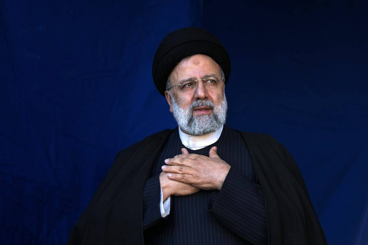 FILE- Iranian President Ebrahim Raisi places his hands on his heart as a gesture of respect to the crowd during the funeral ceremony of the victims of Wednesday’s bomb explosion in the city of Kerman about 510 miles (820 kms) southeast of the capital Tehran, Iran, Jan. 5, 2024. A helicopter carrying Iranian President Ebrahim Raisi suffered a “hard landing” on Sunday, May 19, 2024, Iranian state television reported, without immediately elaborating. (AP Photo/Vahid Salemi, File)