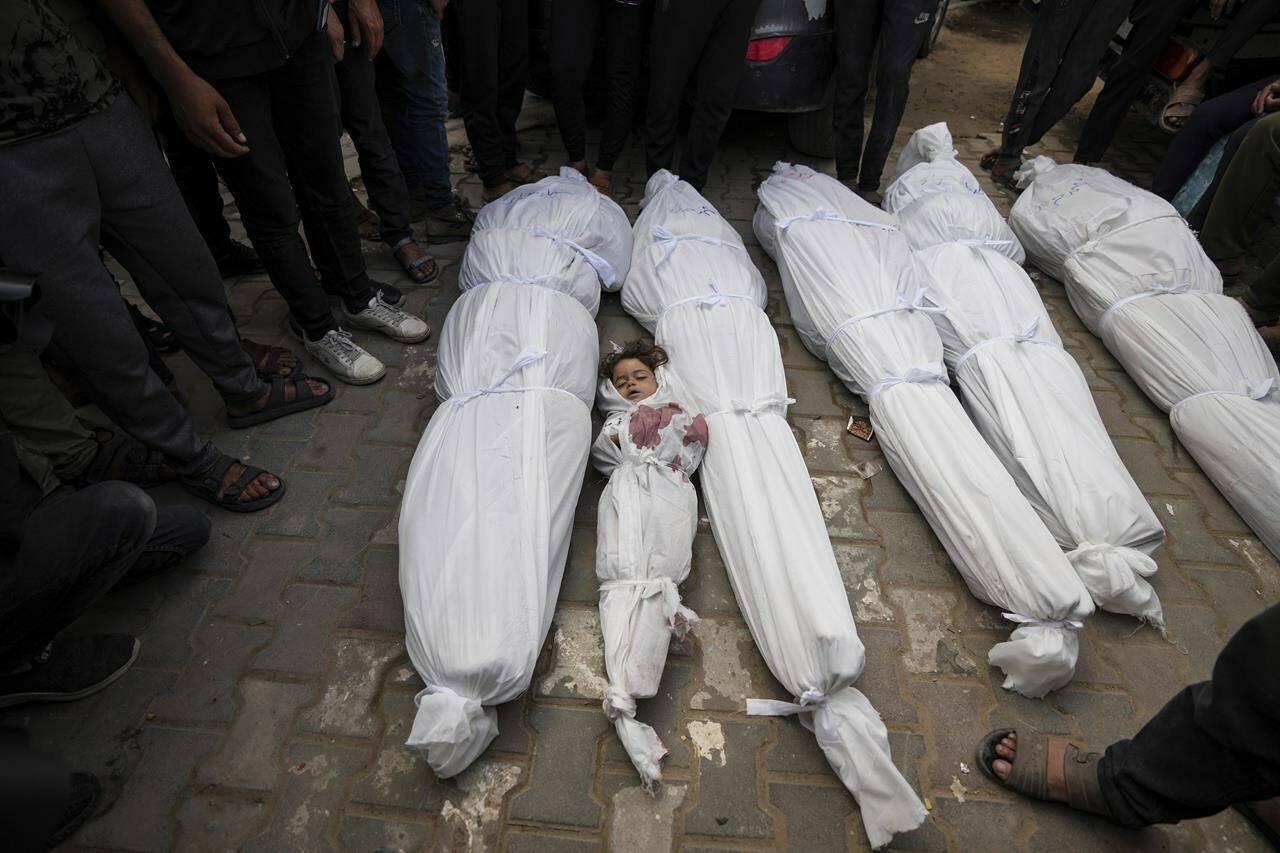 Palestinians mourn their relatives who were killed in an Israeli airstrike in Nuseirat, at the Al Aqsa hospital in Deir al Balah, Gaza Strip, Sunday, May 19, 2024. (AP Photo/Abdel Kareem Hana)