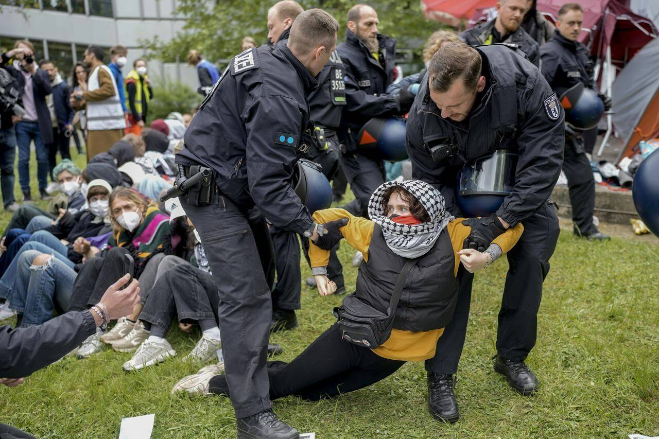 A woman is carried away by police officers during a pro-Palestinians demonstration by the group “Student Coalition Berlin” in the theater courtyard of the ‘Freie Universität Berlin’ university in Berlin, Germany, Tuesday, May 7, 2024. Colleges and universities have long been protected places for free expression without pressure or punishment. But protests over Israel’s conduct of the war in Gaza in its hunt for Hamas after the Oct. 7 massacre has tested that ideal around the world. (AP Photo/Markus Schreiber, File)
