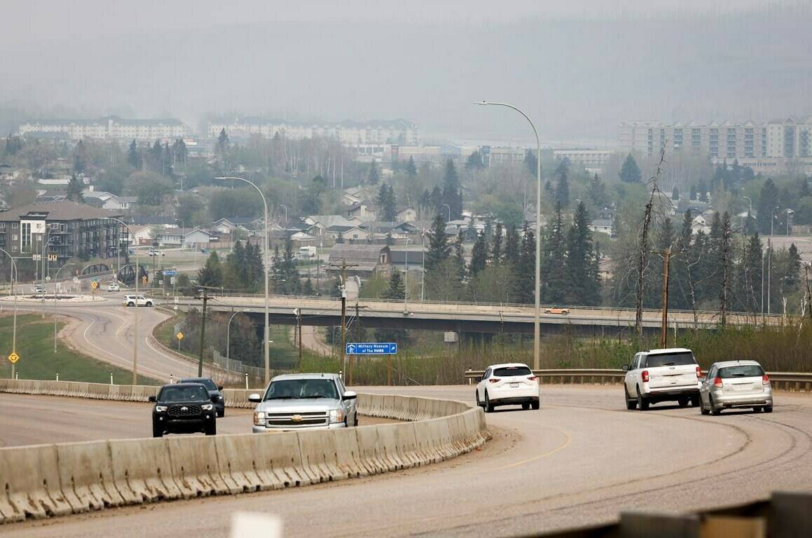As we enter another wildfire season, Environment and Climate Change Canada is advising people to pay attention to air pollution levels and check the Air Quality Health Index – especially on smoky days. Traffic moves along Alberta Highway 63 as wildfire smoke hangs in air in Fort McMurray, Alta., Wednesday, May 15, 2024. THE CANADIAN PRESS/Jeff McIntosh