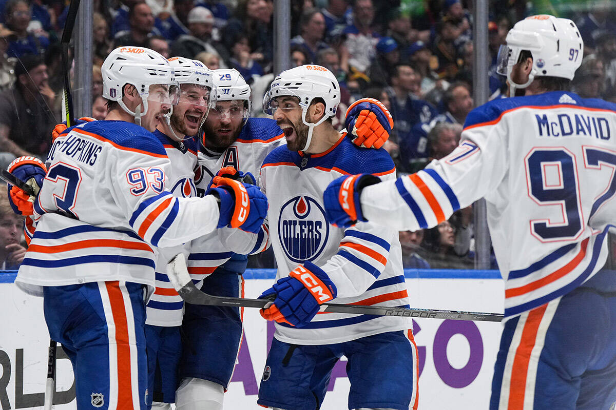 Edmonton Oilers’ Ryan Nugent-Hopkins, from left to right, Zach Hyman, Leon Draisaitl, Evan Bouchard and Connor McDavid celebrate Nugent-Hopkins’ goal during the second period in Game 7 of an NHL hockey Stanley Cup second-round playoff series, in Vancouver, on Monday, May 20, 2024. THE CANADIAN PRESS/Darryl Dyck