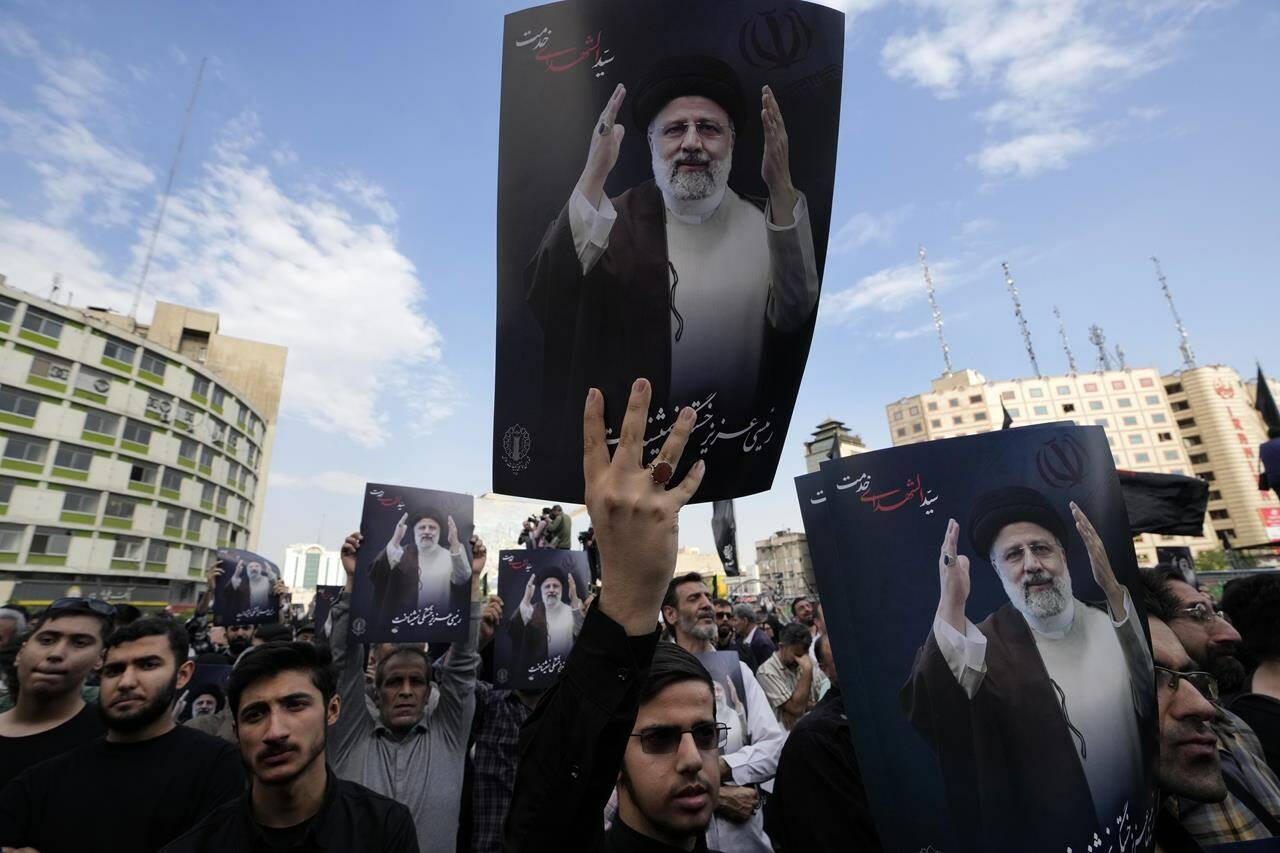People hold up posters of Iranian President Ebrahim Raisi during a mourning ceremony for him at Vali-e-Asr square in downtown Tehran, Iran, Monday, May 20, 2024. President Raisi and the country’s foreign minister were found dead Monday hours after their helicopter crashed in fog, leaving the Islamic Republic without two key leaders as extraordinary tensions grip the wider Middle East. (AP Photo/Vahid Salemi)