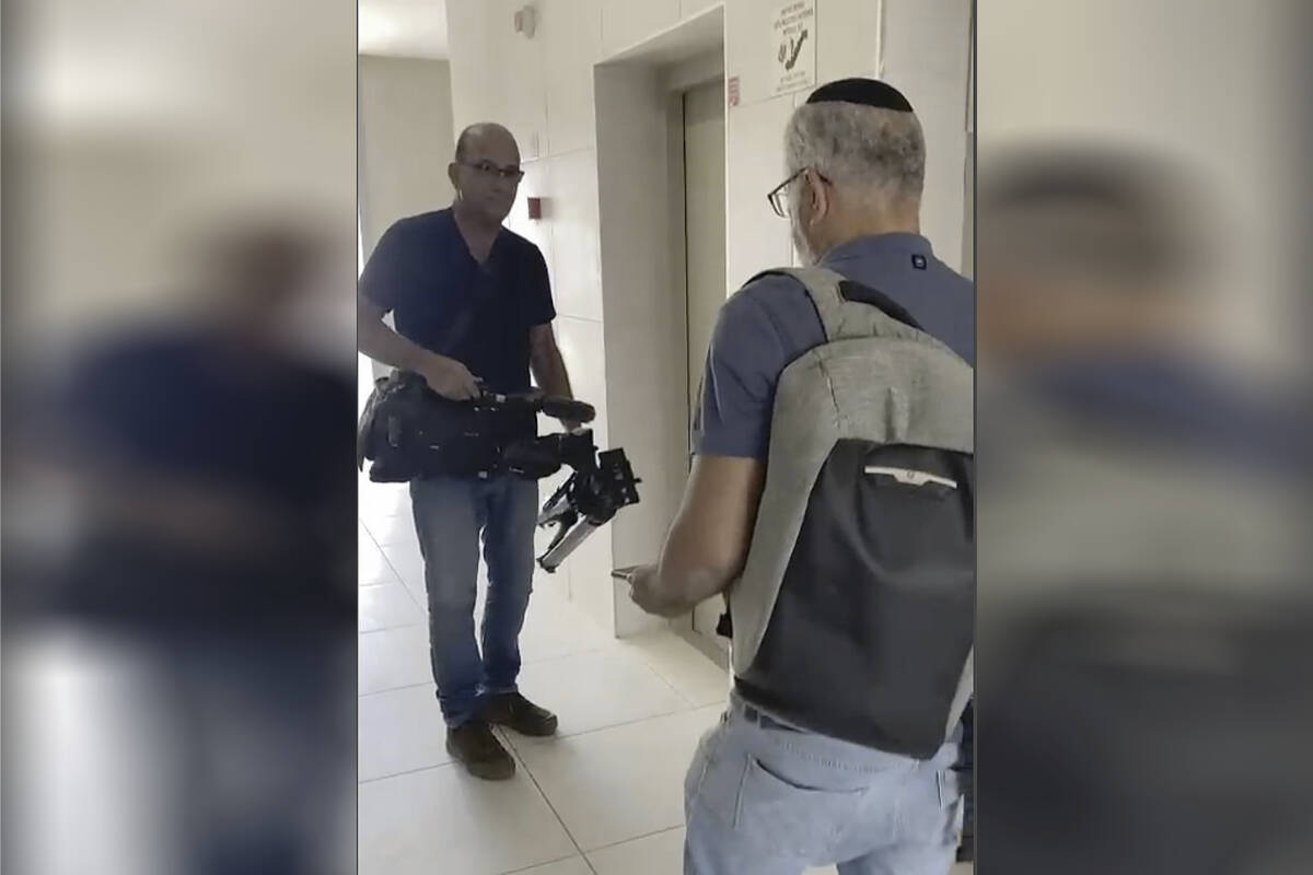 In this image from video, Israeli officials seize AP video equipment from an apartment block in Sderot, Southern Israel, Tuesday, May 21, 2024. Israeli officials seized the camera and broadcasting equipment belonging to The Associated Press in southern Israel on Tuesday, accusing the news organization of violating the country’s new ban on Al Jazeera. Shortly before the equipment was seized, it was broadcasting a general view of northern Gaza. (AP Photo/Josphat Kasire)