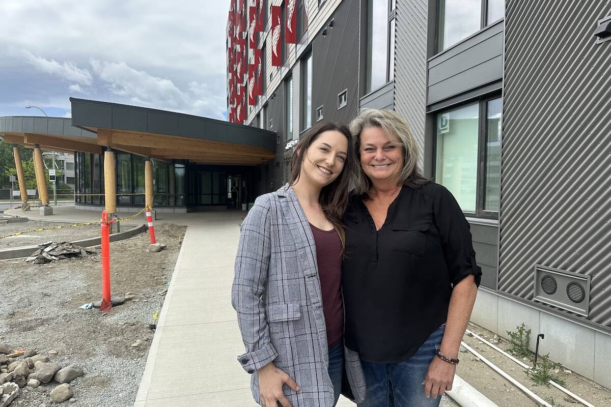 Megan Beckmann (left) and Monique Saebels are trying to keep their hopes up standing outside of the new Okanagan College dorms they are temporarily housed in while evacuated from Hadgraft Wilson Place. (Brittany Webster/Capital News)