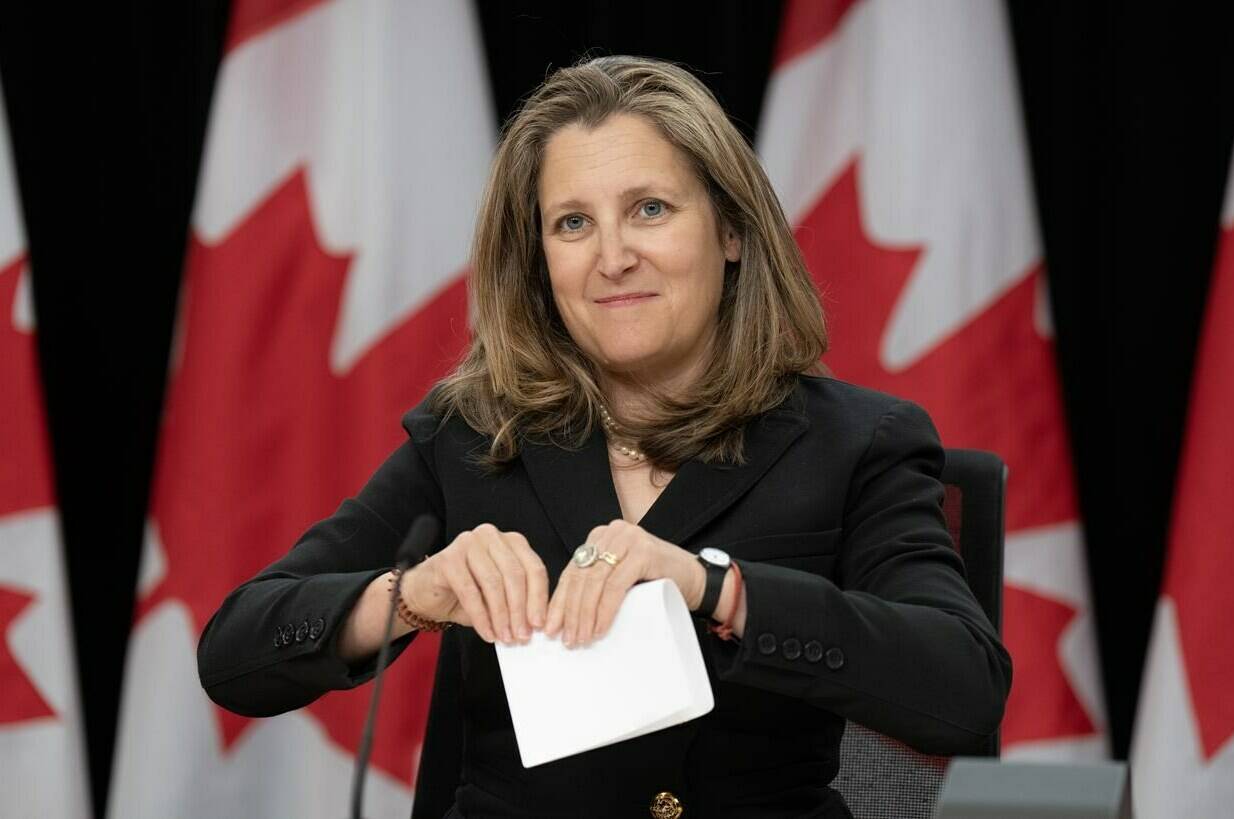 Deputy Prime Minister and Minister of Finance Chrystia Freeland folds a piece of paper after delivering her opening remarks at a news conference, Tuesday, May 21, 2024 in Ottawa. THE CANADIAN PRESS/Adrian Wyld
