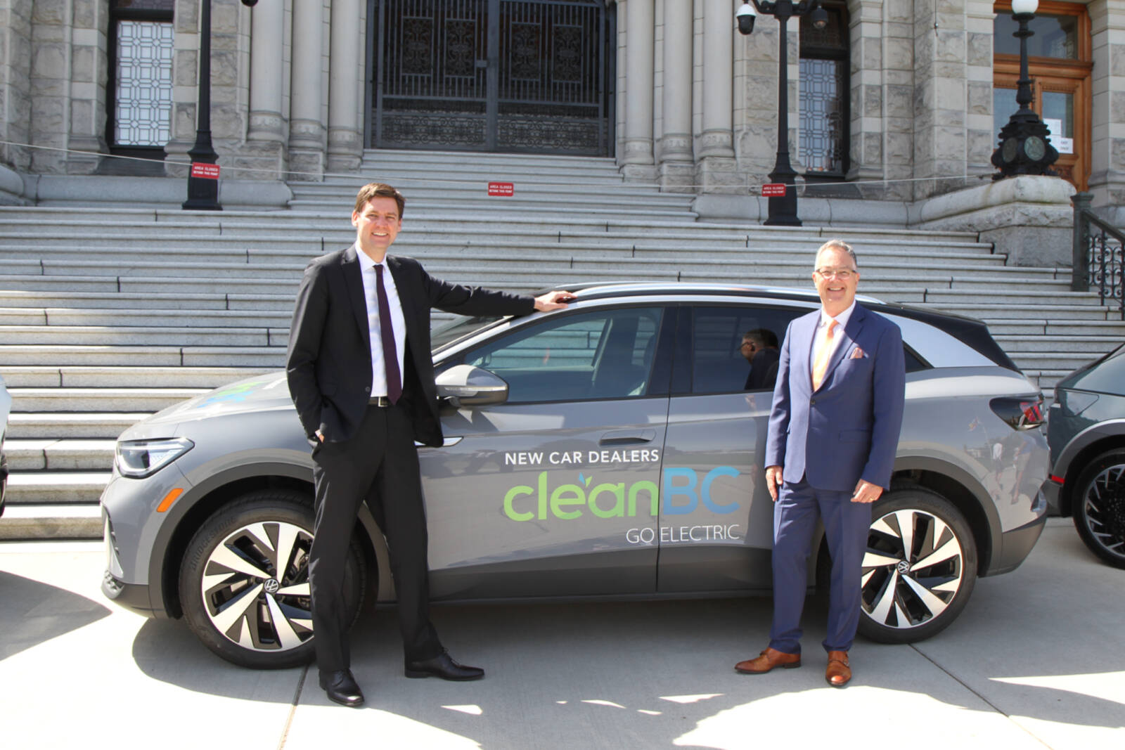 B.C. Premier David Eby and Blair Qualey, from B.C.’s New Car Dealers Association, mark the annual EV Day at the B.C. Legislature. NCDA photo