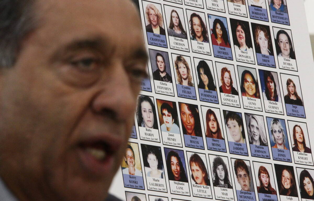 FILE – Photographs of missing women are displayed as Commissioner Wally Oppal speaks during the Missing Women Commission of Inquiry public forum in Vancouver, B.C., on Wednesday January 19, 2011. THE CANADIAN PRESS/Darryl Dyck