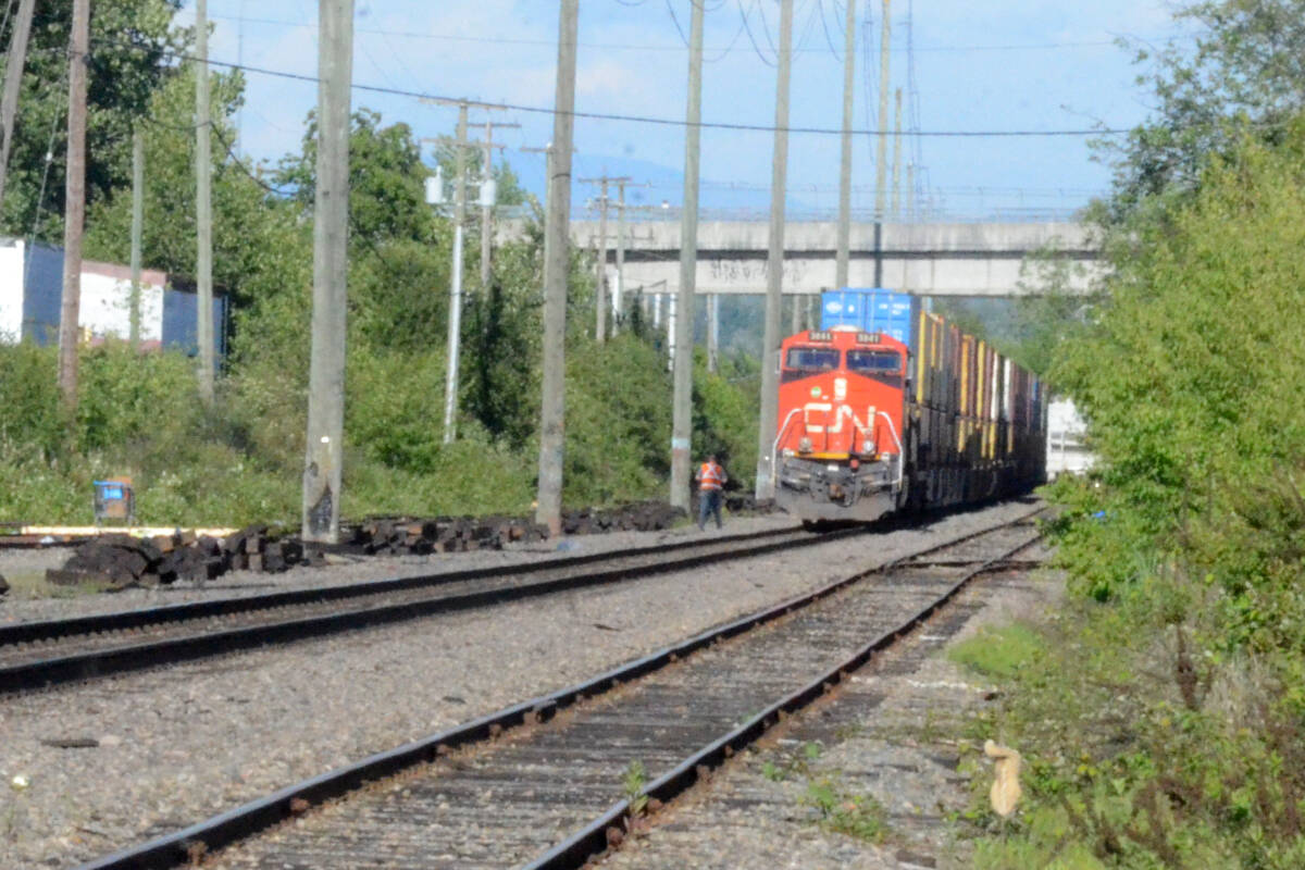 A train was stopped on the rails parallel to the Langley Bypass on Wednesday afternoon after it struck and killed a pedestrian. (Matthew Claxton/Langley Advance Times)