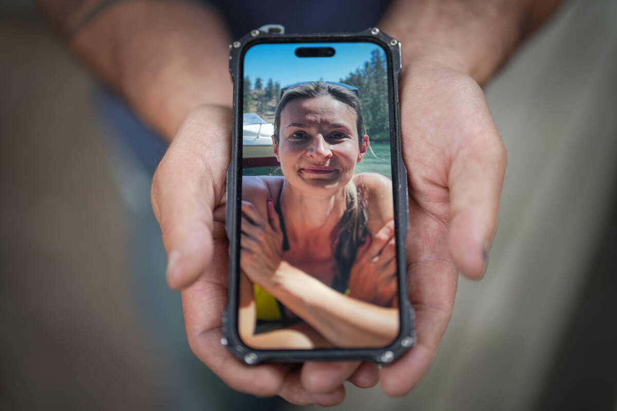 Jason Gaudreault, whose partner Tatjana Stefanski was found dead on April 14 after disappearing a day earlier, shows a photograph of her on his phone, in Lumby, B.C., on Monday, May 13, 2024. RCMP say Stefanski, 44, was last seen on April 13 with her ex-husband before “departing unexpectedly” with him in a black Audi. THE CANADIAN PRESS/Darryl Dyck