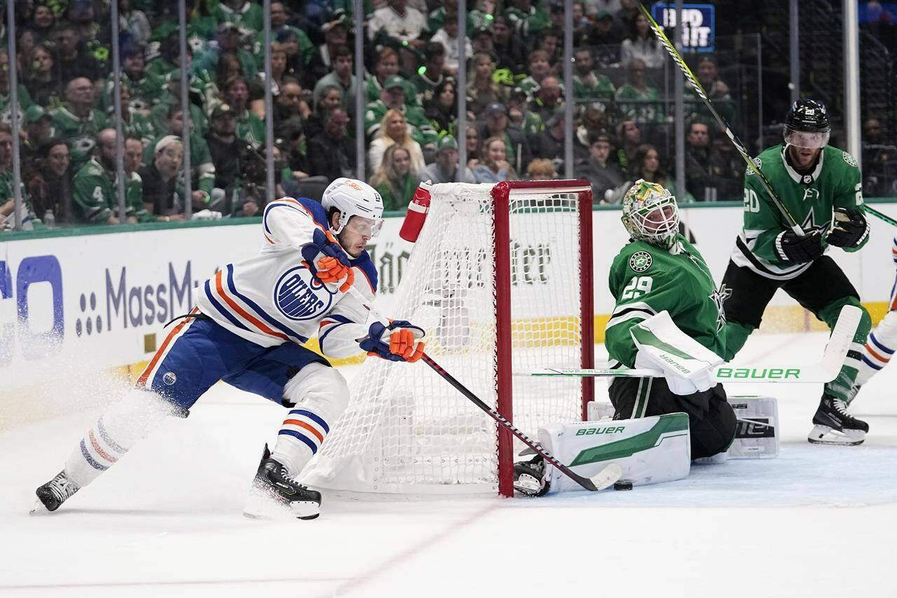 Dallas Stars goaltender Jake Oettinger (29) blocks a shot by Edmonton Oilers centre Mattias Janmark, left, as Stars’ Ryan Suter (20) looks on during the second period in Game 2 of the Western Conference finals in the NHL hockey Stanley Cup playoffs Saturday, May 25, 2024, in Dallas. (AP Photo/Tony Gutierrez)