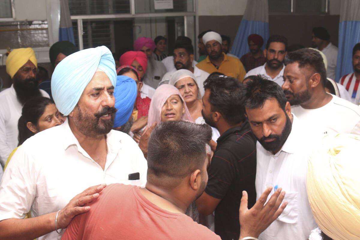 The mother, centre, relatives and friends of Shubhdeep Singh Sidhu, also known around the world by his stage name Sidhu Moose Wala, arrive at a hospital after he was shot in Mansa, Punjab state, India, Sunday, May 29, 2022. On the day of his second death anniversary this week, Canadian fans of the rapper say they will be thinking about his transformation into a political icon after his killing because his music made references to Indian politics and the Sikh faith that remain relevant today.THE CANADIAN PRESS/AP