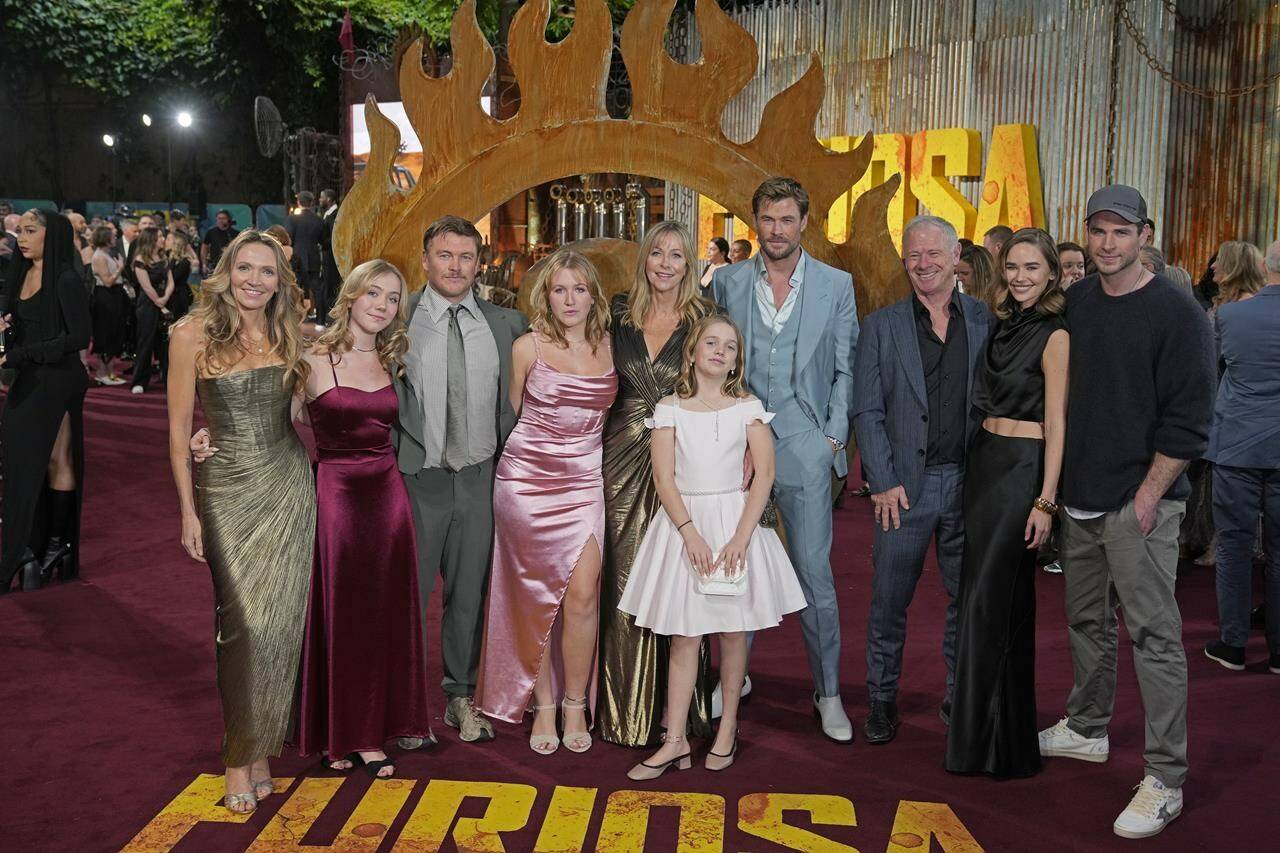 Chris Hemsworth, fourth right, Liam Hemsworth, right, and Gabriella Brooks, second right, pose for photographers upon arrival at the UK Premiere of the film ‘Furiosa: A Mad Max Saga’ in London, Friday, May 17, 2024. (AP Photo/Kin Cheung)
