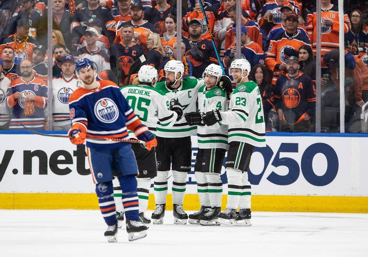 Dallas Stars Matt Duchene (95), Jamie Benn (14), Miro Heiskanen (4) and Esa Lindell (23) celebrate a goal as Edmonton Oilers’ Zach Hyman (18) skates past during third period third-round NHL playoff action in Edmonton on Monday May 27, 2024.THE CANADIAN PRESS/Jason Franson