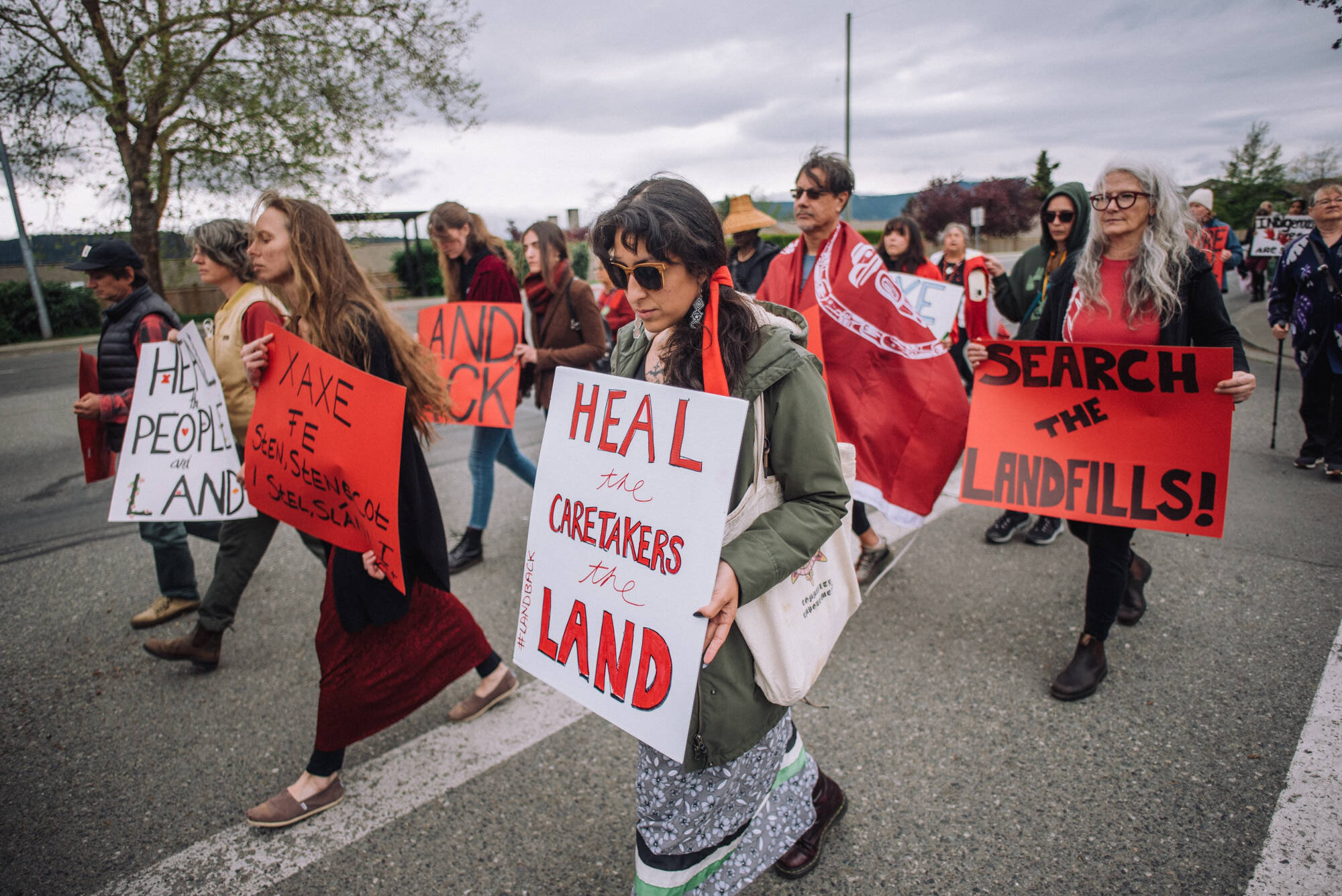 Dozens marched down West Saanich Road in W̱JOȽEȽP near Brentwood Bay to honour missing and murdered Indigenous relatives on May 5, Red Dress Day. Photo by Mike Graeme