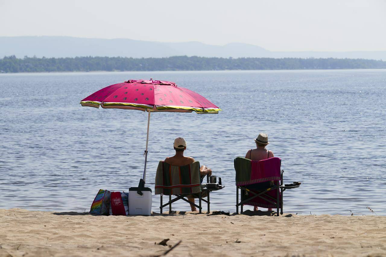People take to the waters and shores of the Ottawa River in the Ottawa suburb of Constance Bay on Tuesday, July 6, 2023. The Weather Network is predicting more sunshine and warmer temperatures for the summer. THE CANADIAN PRESS/Sean Kilpatrick