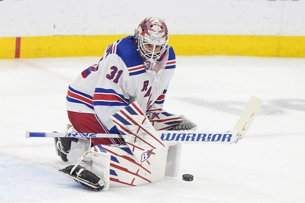 New York Rangers goaltender Igor Shesterkin blocks a shot during the first period of Game 4 during the Eastern Conference finals of the NHL hockey Stanley Cup playoffs against the Florida Panthers, Tuesday, May 28, 2024, in Sunrise, Fla. (AP Photo/Wilfredo Lee)
