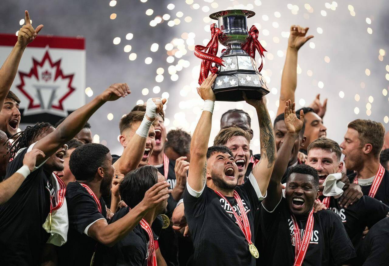 Vancouver Whitecaps’ Ryan Raposo hoists the Voyageurs Cup after Vancouver defeated CF Montreal 2-1 during the Canadian Championship soccer final, in Vancouver, on Wednesday, June 7, 2023. Toronto FC will play Canadian Premier League champion Forge FC in one Canadian Championship semifinal with the defending champion Vancouver whitecaps taking on ether CPL’s Pacific FC or Atletico Ottawa in the other. THE CANADIAN PRESS/Darryl Dyck