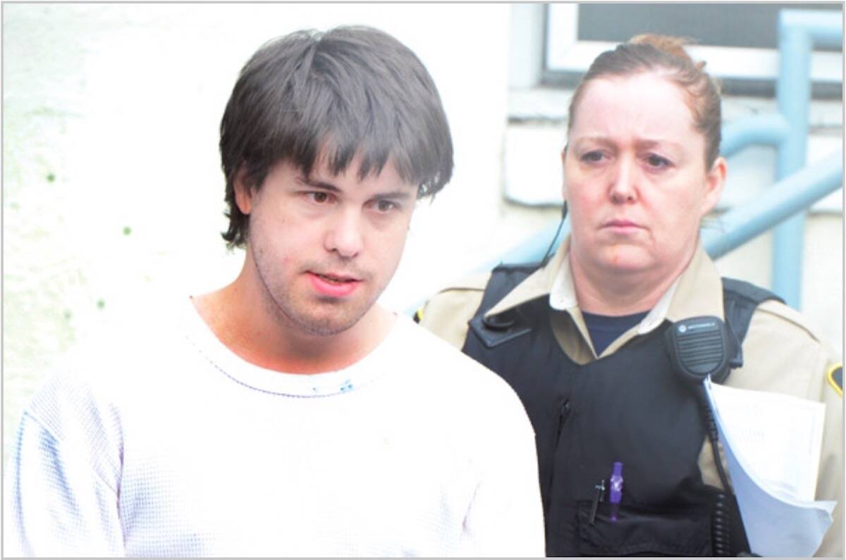 Graham Dodge being escorted from the Penticton courthouse in 2013 after breaching probation. (Black Press Media/File)