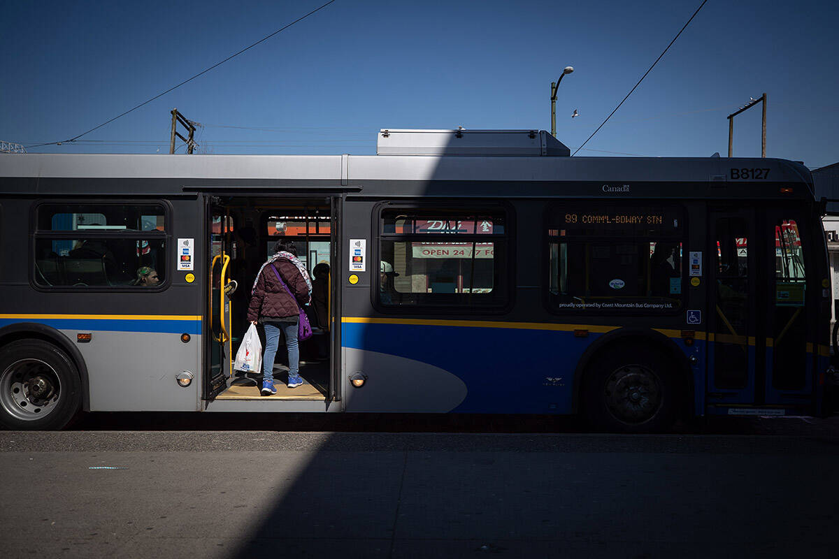 A woman boards a transit bus through rear doors, in Vancouver, on Friday, March 20, 2020. Vancouver police are looking for additional witnesses after a man was charged with sexual assault after allegedly groping a 15-year-old girl on a bus in the city’s Mount Pleasant neighbourhood on May 17, 2024. THE CANADIAN PRESS/Darryl Dyck