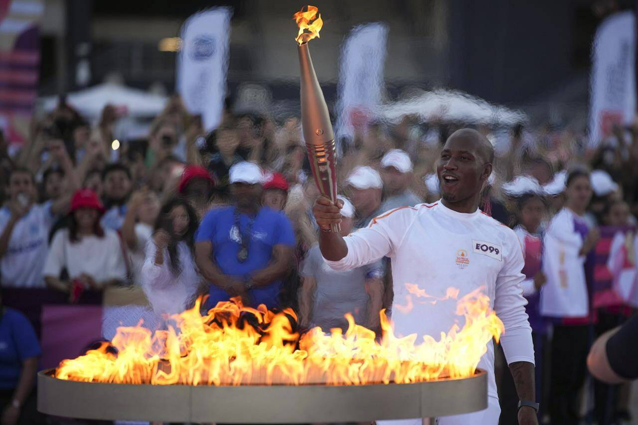 Canadian officials are warning that major international sporting events are prime targets for cybercriminals and hacktivists looking to fatten their wallets, promote their causes or pilfer secrets. Torchbearer Didier Drogba of France holds the torch to light the cauldron at the Velodrome stadium in Marseille, southern France, Thursday, May 9, 2024. THE CANADIAN PRESS/AP-Daniel Cole