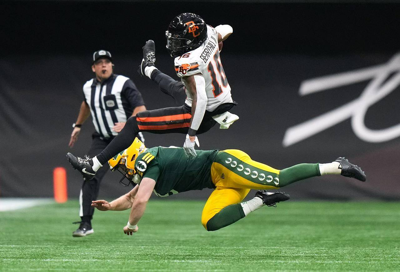 B.C. Lions’ Stanley Berryhill III, top, is upended by Edmonton Elks kicker Jake Julien as he returns a punt during the first half of a pre-season CFL football game, in Vancouver, on Friday, May 31, 2024. THE CANADIAN PRESS/Darryl Dyck