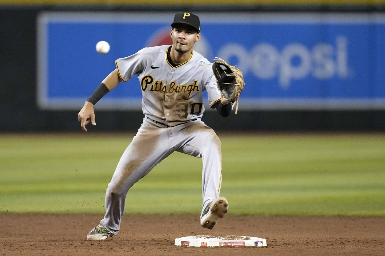 FILE - Pittsburgh Pirates shortstop Tucupita Marcano takes a throw down to second base during the fifth inning of a baseball game against the Arizona Diamondbacks, July 7, 2023, in Phoenix. San Diego Padres’ Marcano is under investigation by Major League Baseball for allegedly betting on baseball and could be subject to a possible lifetime ban, according to a person familiar with the probe who spoke to The Associated Press on condition of anonymity because the investigation is ongoing. (AP Photo/Ross D. Franklin, File)