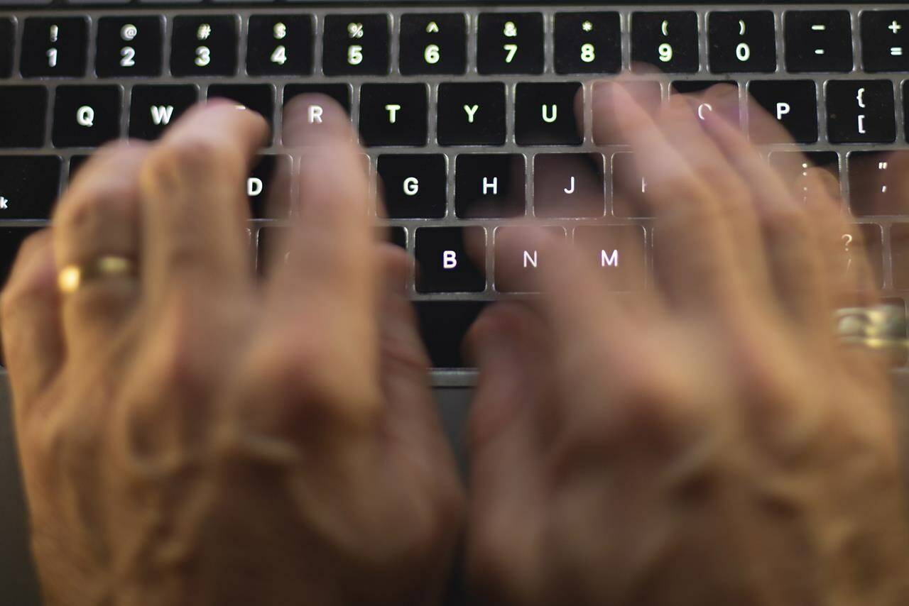 A man uses a computer keyboard in Toronto in this Sunday, Oct. 9 photo illustration. The ransomware business is booming in Canada. Recent victims have included large corporations such as retailer London Drugs, as well as the City of Hamilton, Ont., and the government of Newfoundland and Labrador. THE CANADIAN PRESS/Graeme Roy