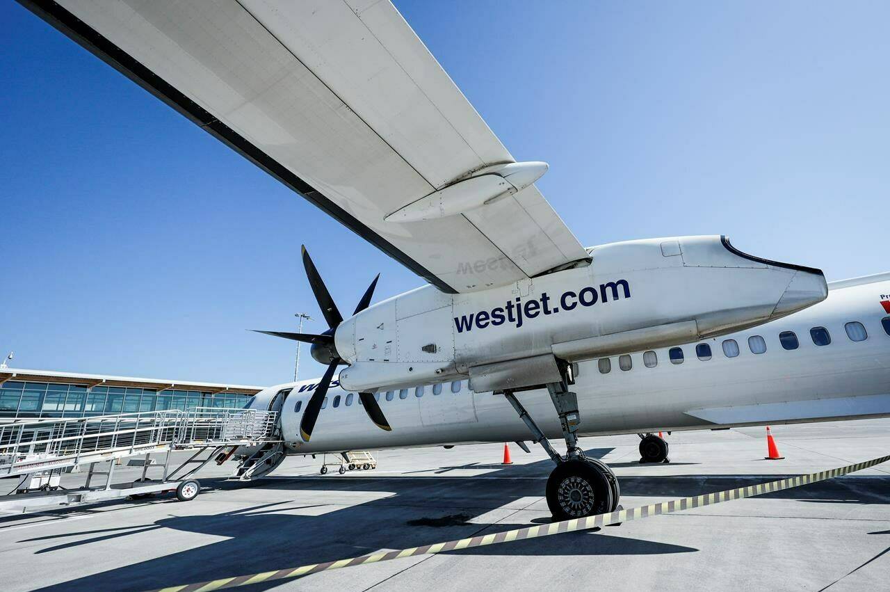 WestJet Airlines says it is replacing its basic fare with a new category that does away with a free carry-on bag and other perks once thought of as a given. A WestJet Encore Bombardier Q400 twin-engined turboprop aircraft is prepared for a flight in Kamloops, Saturday, June 3, 2023.THE CANADIAN PRESS/Jeff McIntosh