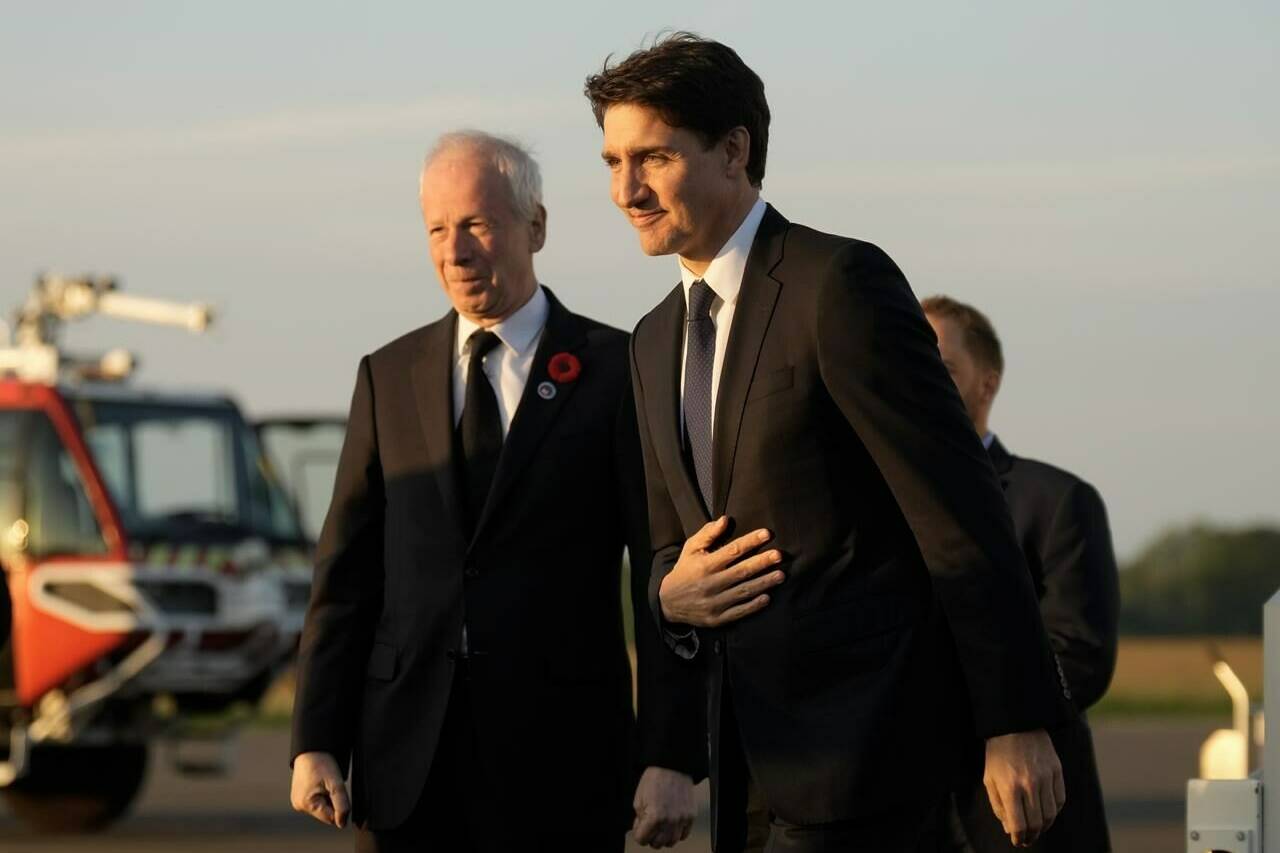 Prime Minister Justin Trudeau walks with Canadian Ambassador to France and Special Envoy to the European Union Stephane Dion as he arrives in Deauville, France, Wednesday, June 5, 2024. THE CANADIAN PRESS/Adrian Wyld