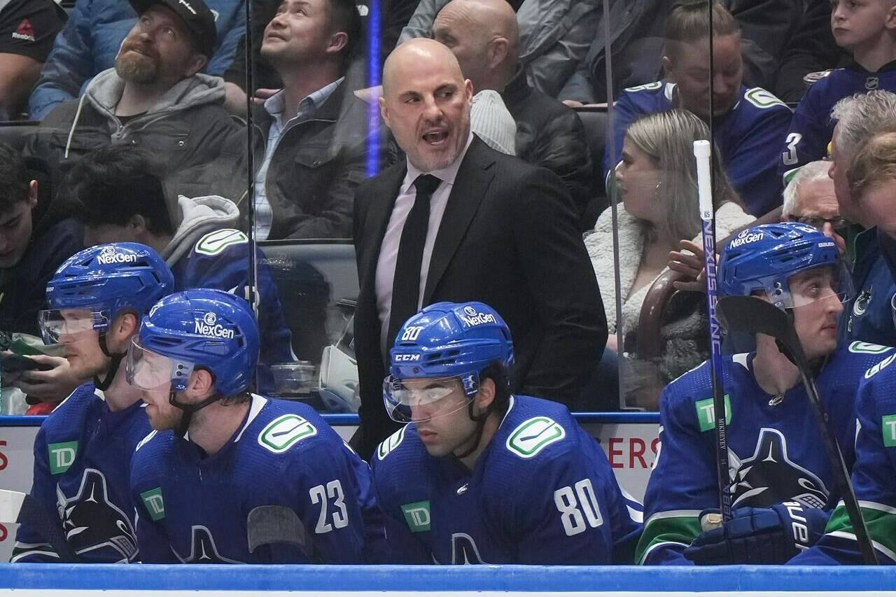 Vancouver Canucks head coach Rick Tocchet stands on the bench during the first period of an NHL hockey game against the Pittsburgh Penguins, in Vancouver, on Tuesday, February 27, 2024. Watching hockey hasn’t been easy for Vancouver Canucks head coach Rick Tocchet recently. THE CANADIAN PRESS/Darryl Dyck