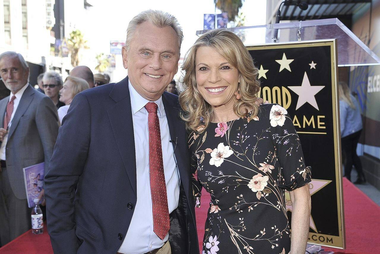 FILE - Pat Sajak, left, and Vanna White, from “Wheel of Fortune,” attend a ceremony honoring Harry Friedman with a star on the Hollywood Walk of Fame in Los Angeles on Nov. 1, 2019. (Photo by Richard Shotwell/Invision/AP, File)